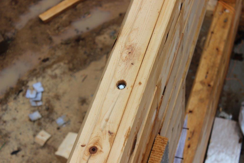 All of our logs come pre-drilled and recessed so that the supplied lags and washers sit below the surface.  Each row of logs will have the lags staggered so that they don't hit each other.