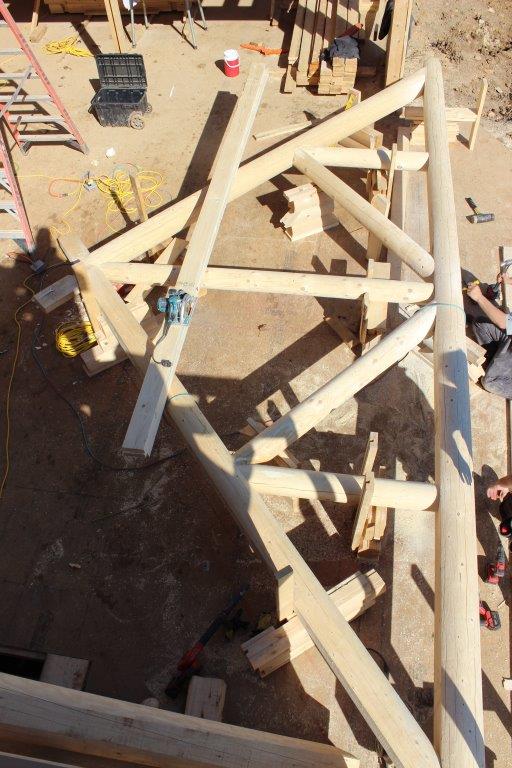 This log truss was assembled on the ground.  It will be lifted into place by a crane.