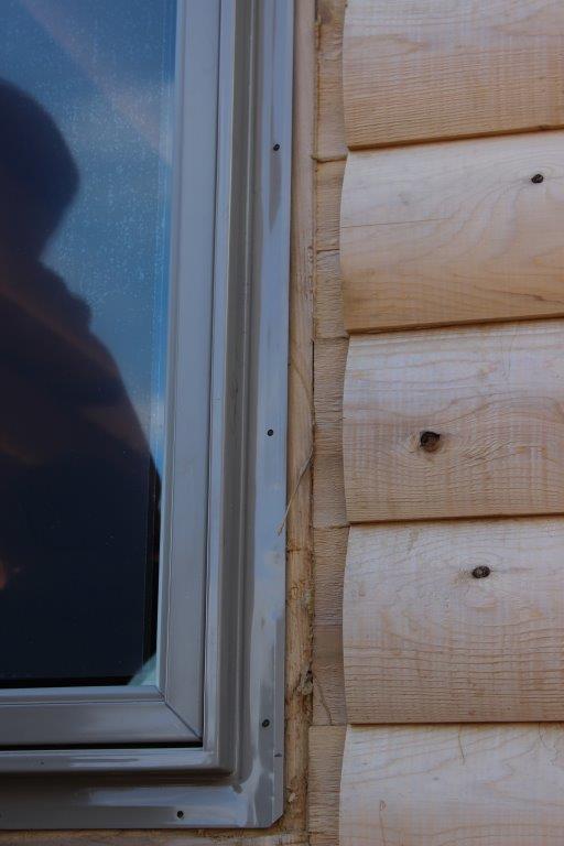 A closer look at the window installed into the buck.  Note how the logs are cut back so that the cedar trim can be installed.